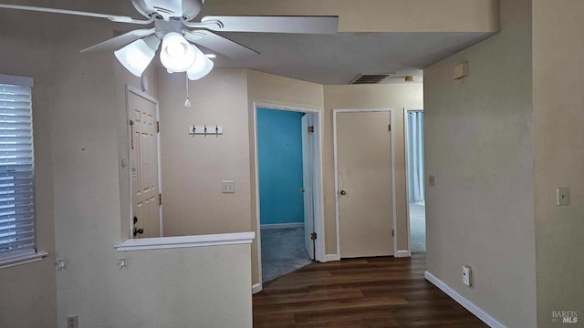 corridor with visible vents, baseboards, and wood finished floors