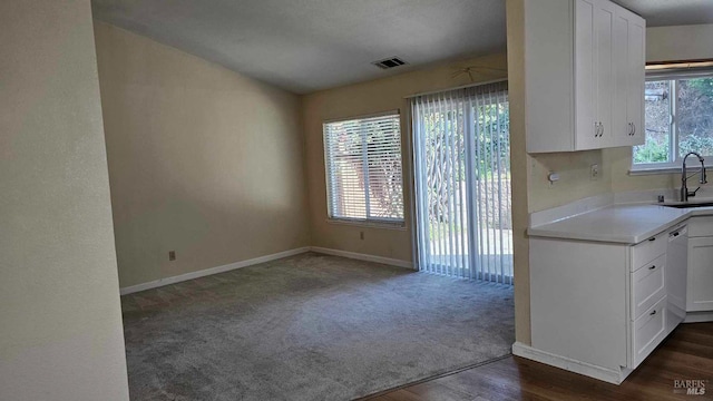 kitchen featuring visible vents, white cabinets, dishwasher, a healthy amount of sunlight, and a sink