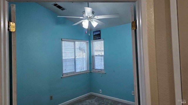 unfurnished room with ceiling fan, visible vents, and baseboards