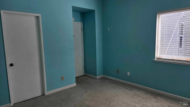 spare room with carpet flooring and baseboards