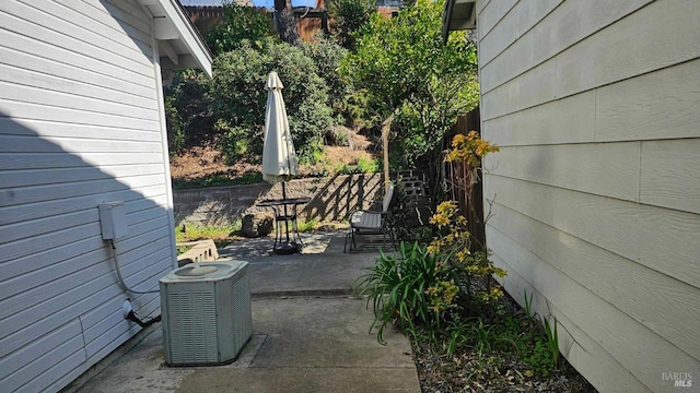 view of patio / terrace featuring cooling unit and fence