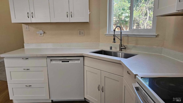 kitchen with a sink, white cabinetry, light countertops, dishwasher, and white electric range oven