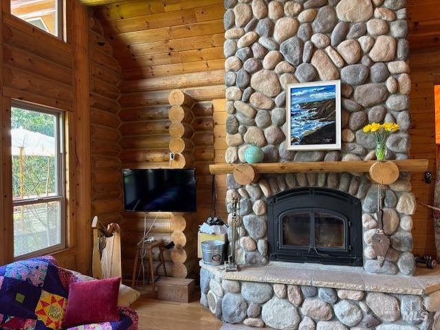 living room featuring rustic walls, wooden ceiling, vaulted ceiling, and wood finished floors