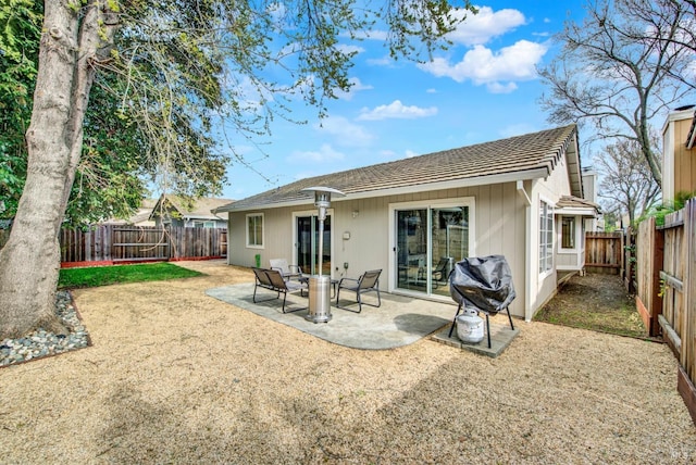 back of house featuring a fenced backyard and a patio