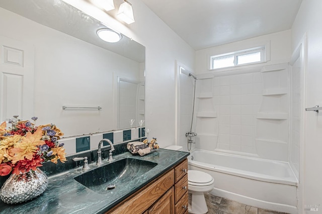 bathroom featuring washtub / shower combination, vanity, and toilet