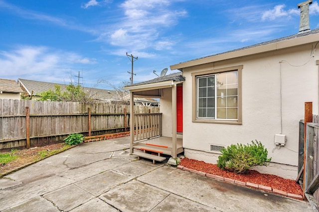 view of patio featuring fence