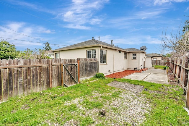 back of house featuring a patio area, a fenced backyard, and stucco siding