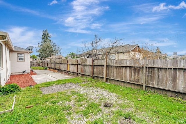 view of yard with a patio area and a fenced backyard