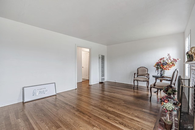 unfurnished room with a fireplace and wood finished floors