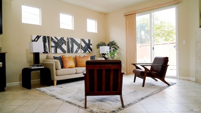 living area featuring light tile patterned floors and baseboards