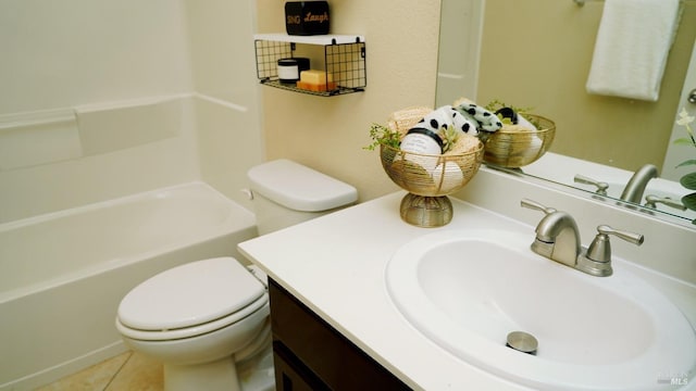 bathroom featuring toilet, vanity, and tile patterned flooring