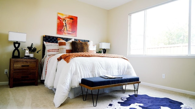 bedroom with carpet flooring, multiple windows, and baseboards