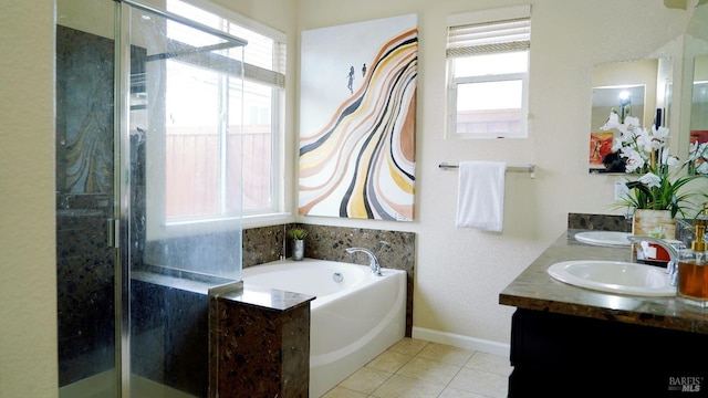 bathroom with plenty of natural light, a garden tub, a sink, and a stall shower