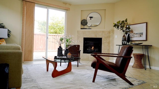 sitting room with tile patterned floors, a fireplace, and baseboards