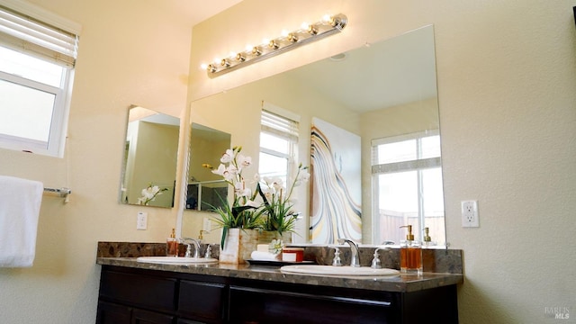 full bath with double vanity and a sink