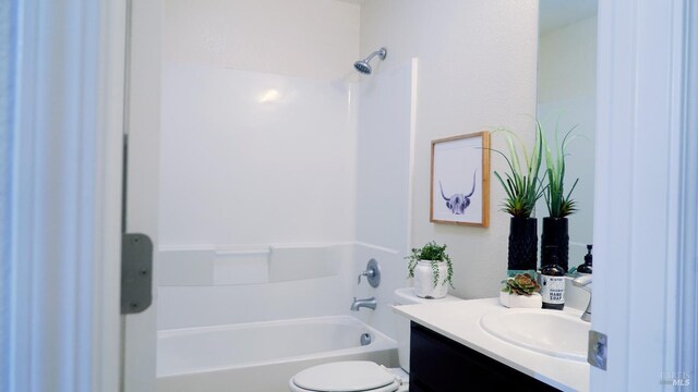 bathroom with toilet, vanity, and bathing tub / shower combination