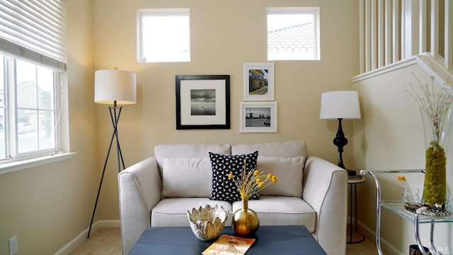 living room featuring plenty of natural light, baseboards, and carpet floors