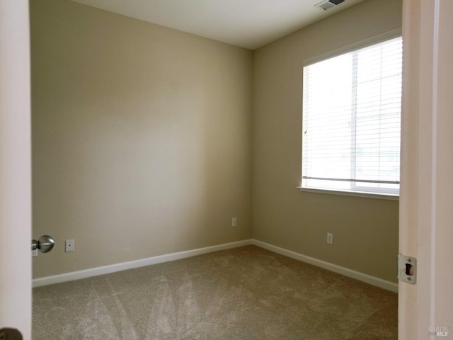 carpeted spare room with baseboards and visible vents