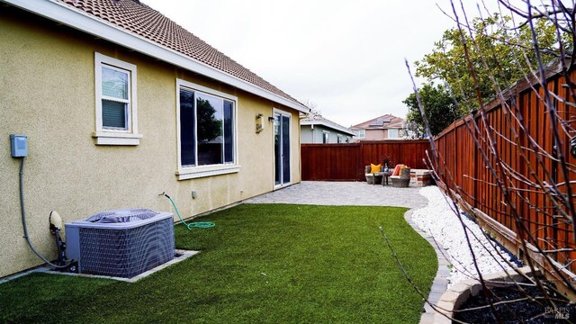 view of yard featuring central air condition unit, a patio, and a fenced backyard