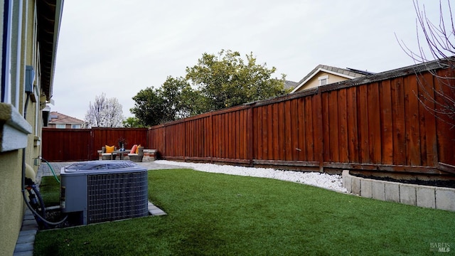 view of yard with central AC unit and a fenced backyard