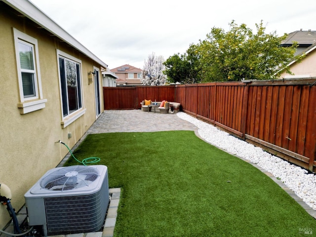 view of yard with cooling unit, a fenced backyard, and a patio area