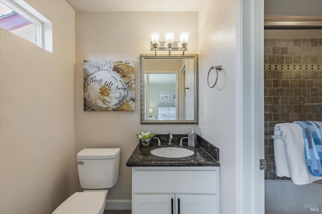 bathroom with toilet and vanity