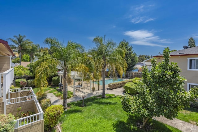 view of yard featuring a fenced in pool and fence