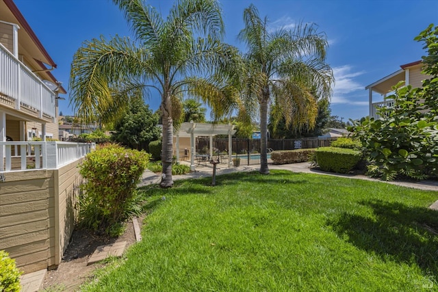 view of yard with fence, a fenced in pool, and a pergola