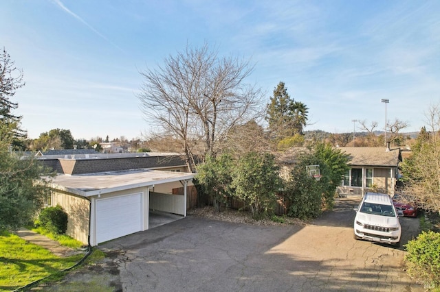 view of front of property featuring a garage and aphalt driveway