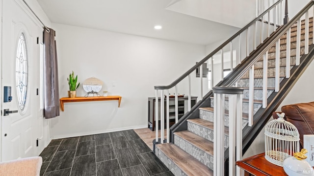 stairs with recessed lighting, wood finished floors, and baseboards