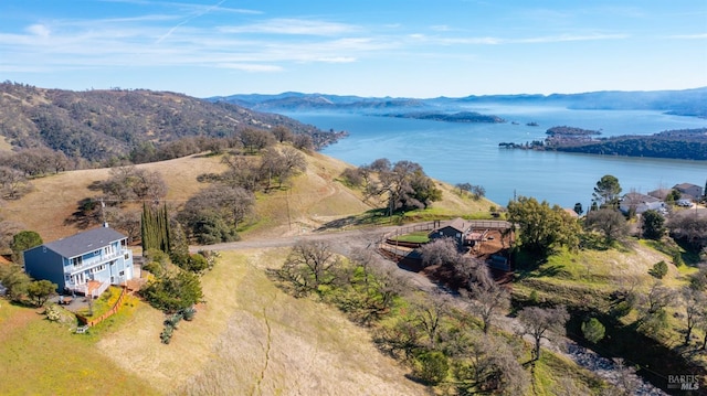 birds eye view of property featuring a water and mountain view