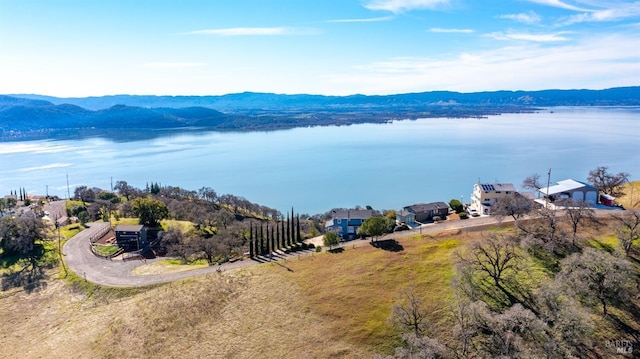 birds eye view of property with a water and mountain view