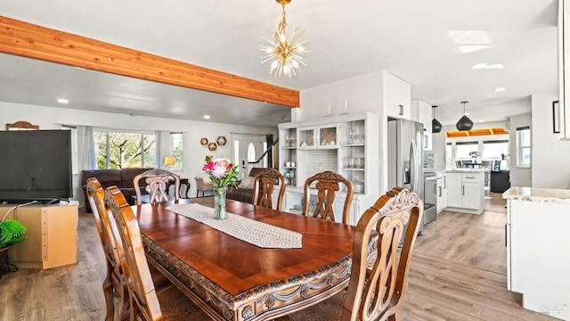 dining room with light wood-style floors, a chandelier, beam ceiling, and recessed lighting