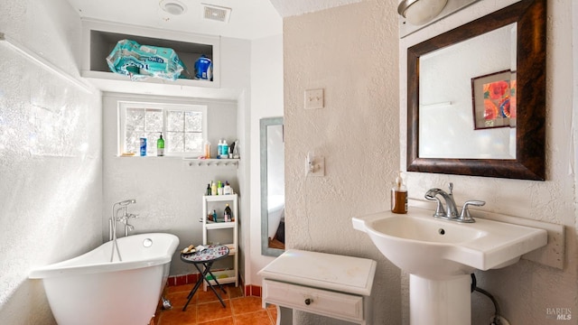 790 Tilton Rd, Sebastopol, CA 95472 - bathroom with a textured wall, a freestanding bath, and tile patterned floors