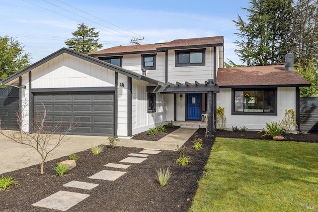 view of front of property featuring driveway, a front lawn, and an attached garage