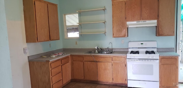 kitchen featuring white range with gas cooktop, open shelves, a sink, light countertops, and under cabinet range hood