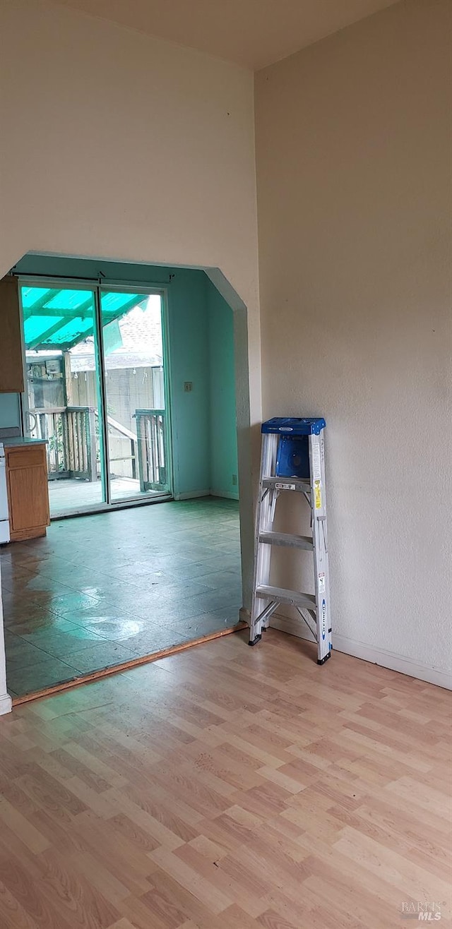 additional living space with wood finished floors and baseboards