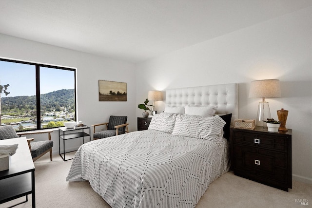 bedroom with light carpet and a mountain view