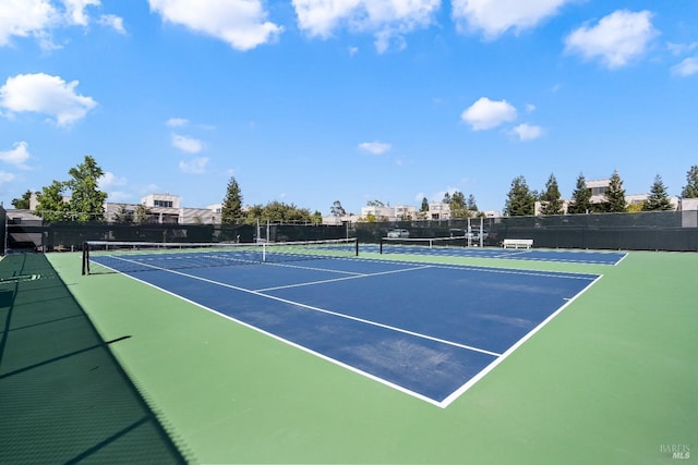 view of sport court featuring fence