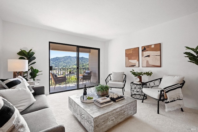 living room featuring light carpet and a mountain view