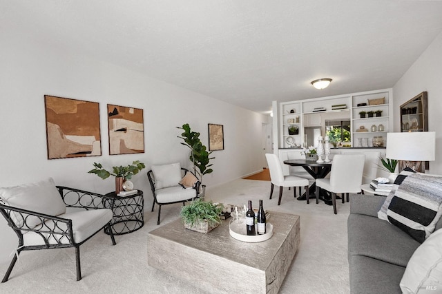 living area with a textured ceiling and light colored carpet