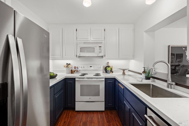 kitchen with dark wood-style floors, white cabinets, a sink, blue cabinets, and white appliances