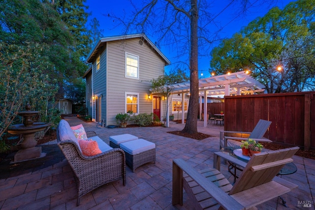 view of patio featuring fence, a storage unit, a pergola, and an outbuilding