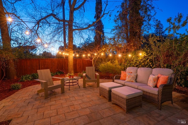 patio terrace at dusk with fence and an outdoor hangout area