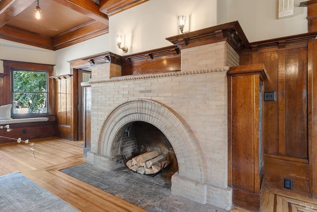 details with a fireplace with flush hearth, ornamental molding, and wood finished floors