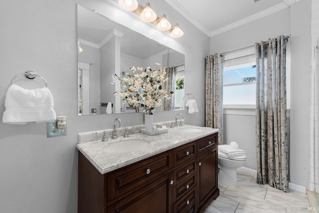 bathroom featuring toilet, marble finish floor, crown molding, and a sink