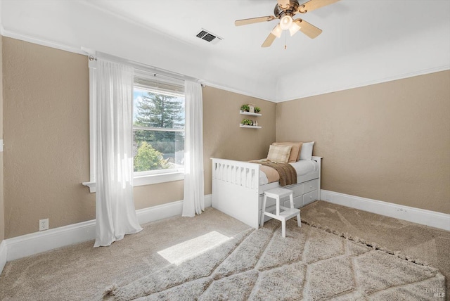 carpeted bedroom with visible vents, ceiling fan, and baseboards