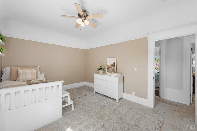 bedroom featuring baseboards, a ceiling fan, and light colored carpet