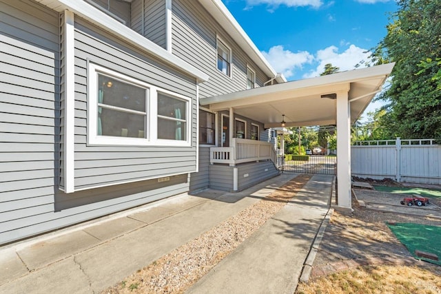 view of side of home featuring fence and a patio