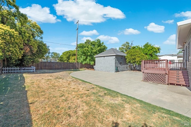 view of yard featuring a fenced backyard, a deck, and a patio